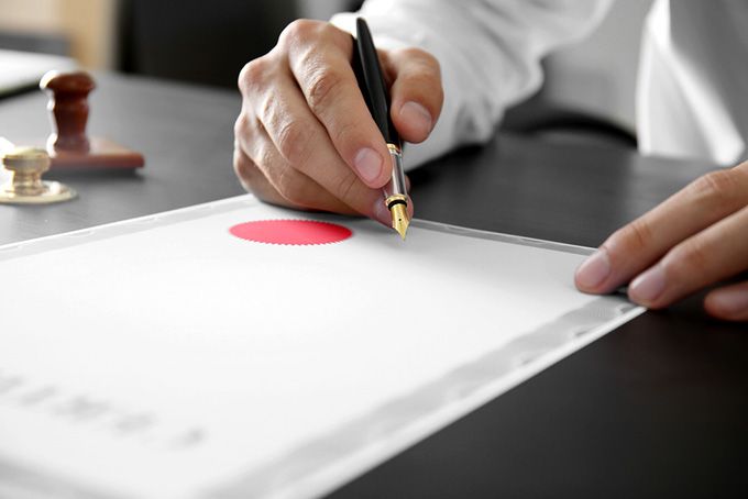 Coursera data science: man signing a certificate.